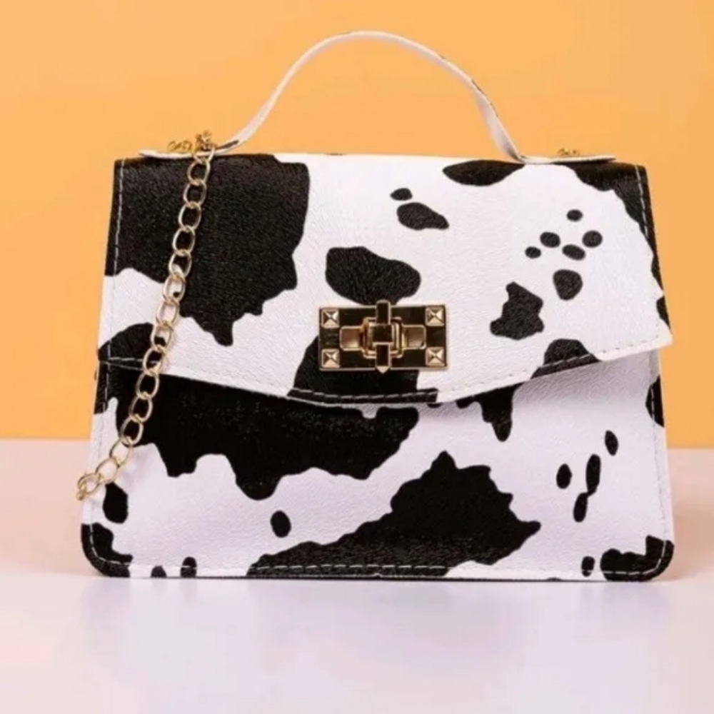 New ladys cow vynil print small latch purse.